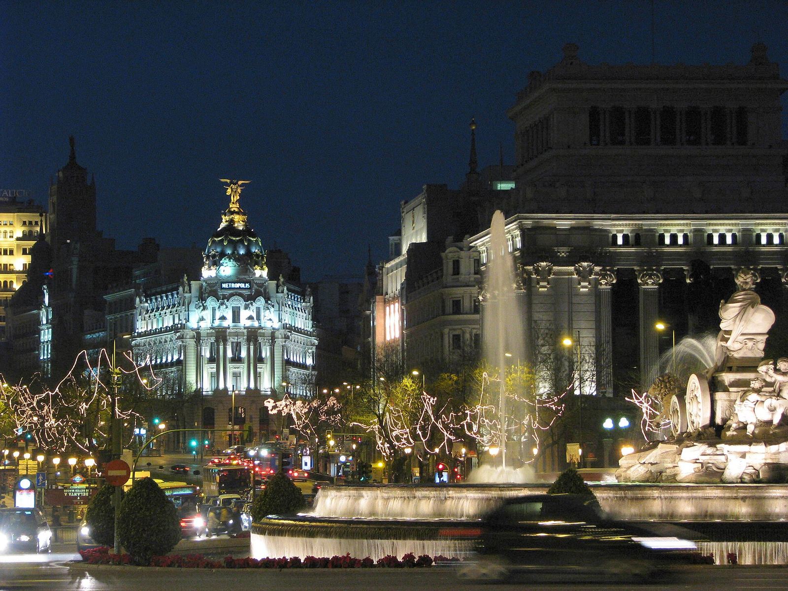 Plaza de Cibeles and the Metropolis building lit at night in Madrid
